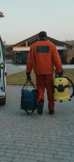 A Kärcher service technician carrying equipment