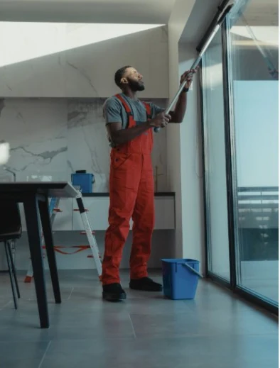 A Kärcher professional cleaning a large window
